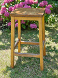 A vintage wooden lab stool