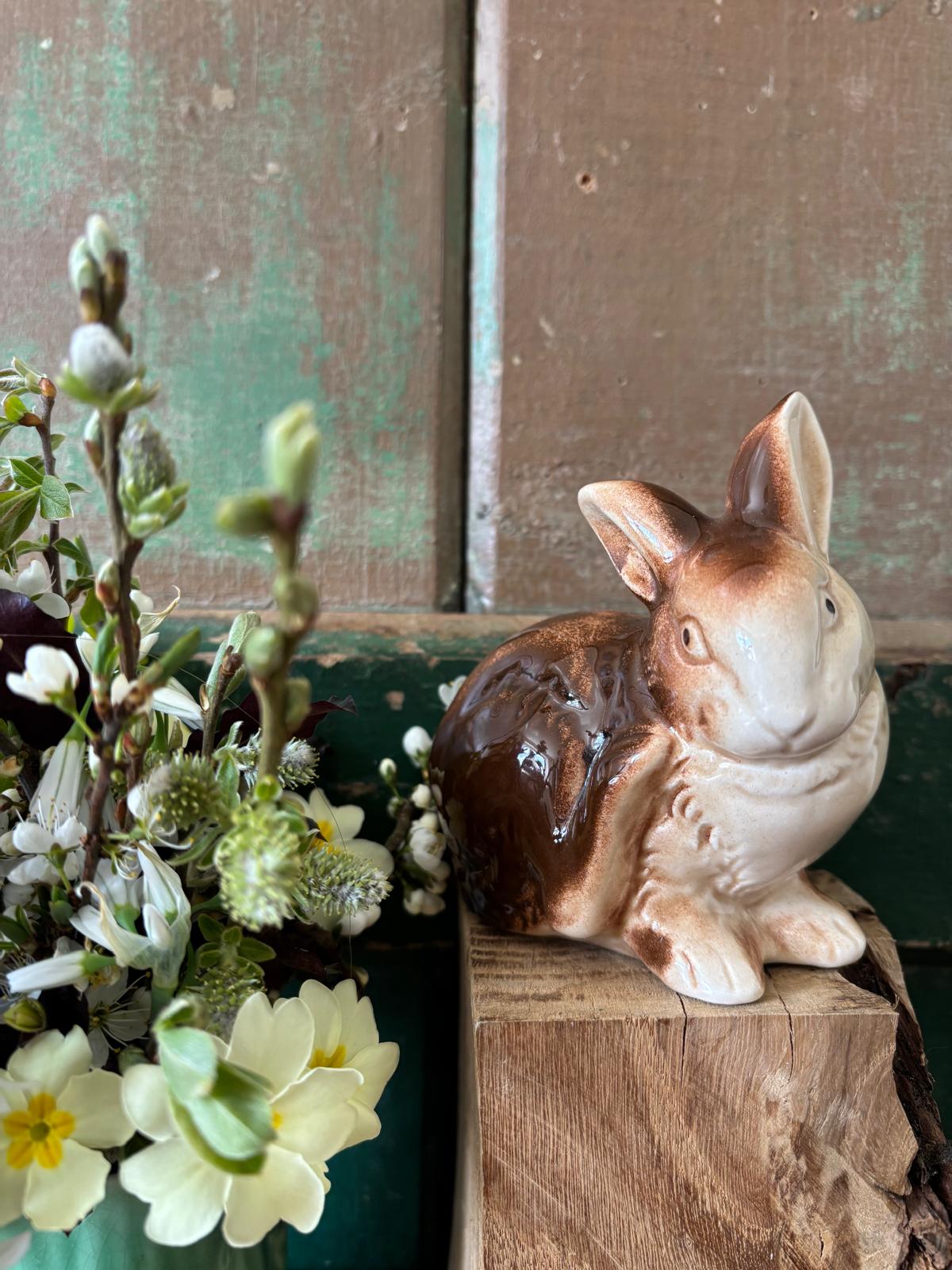 Ceramic rabbit figurine scratching