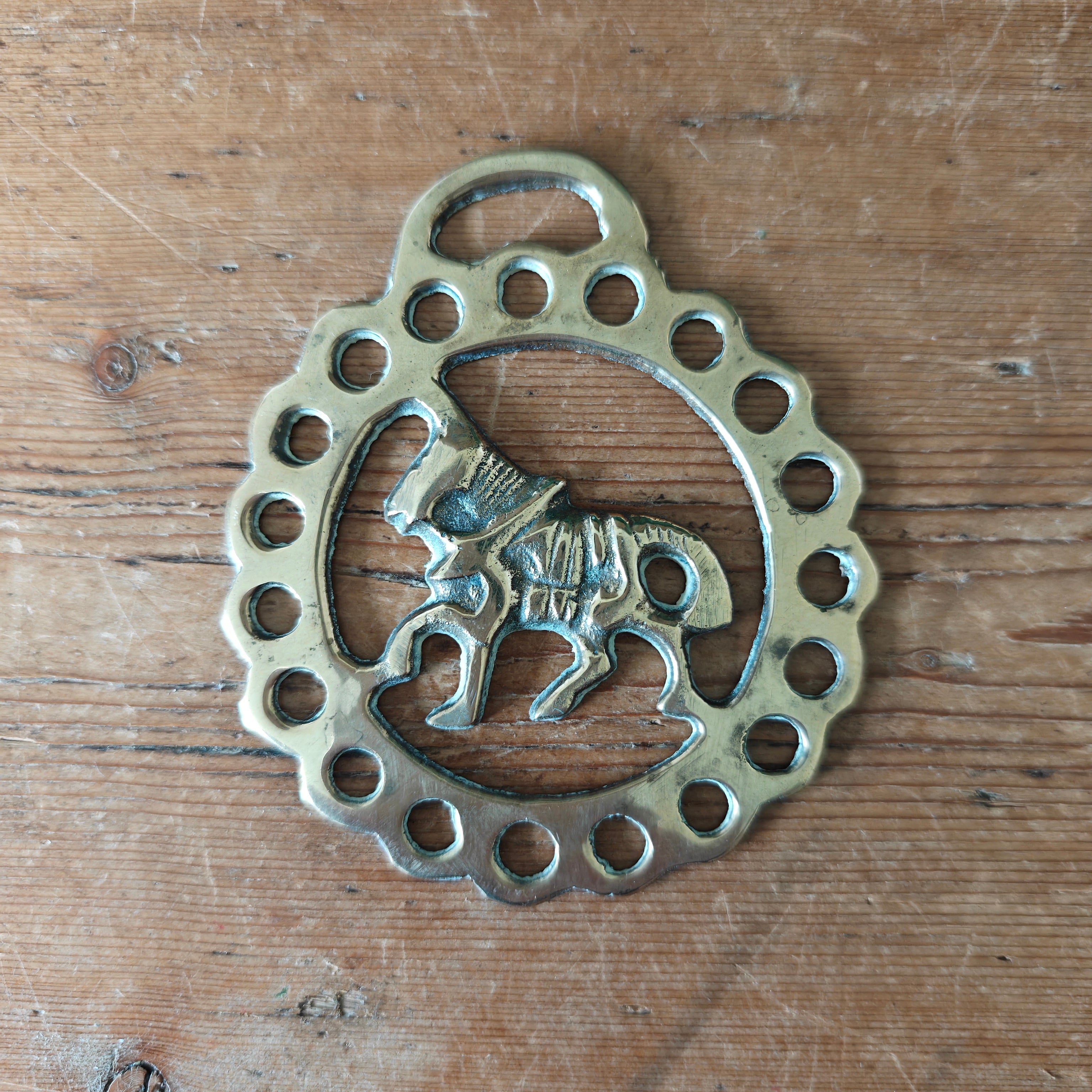 Decorative horse brass with horse design