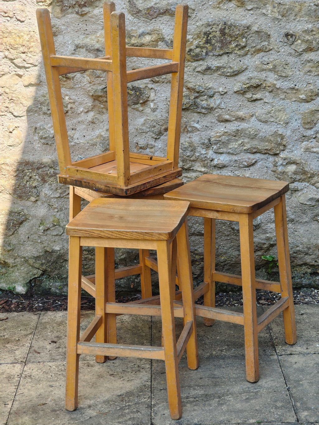 A group of rustic wooden lab stools