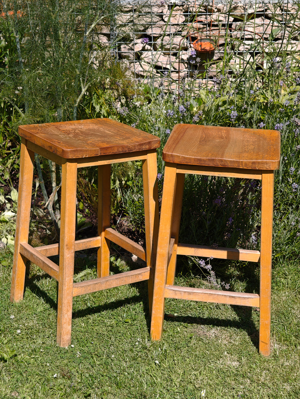A pair of vintage wooden lab stools