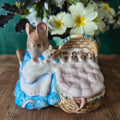 Decorative figurine of a mouse with her babies in a basket 