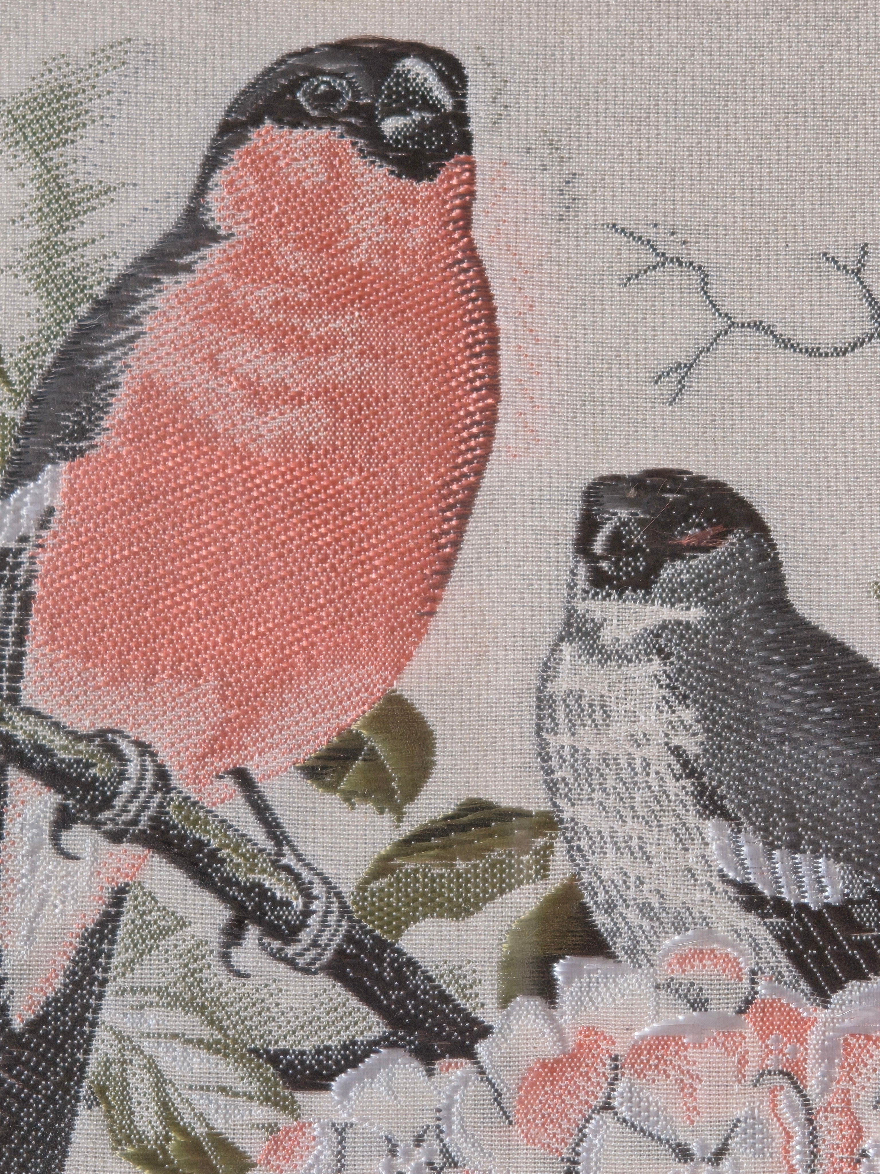 Woven picture of two birds on a branch with flowers