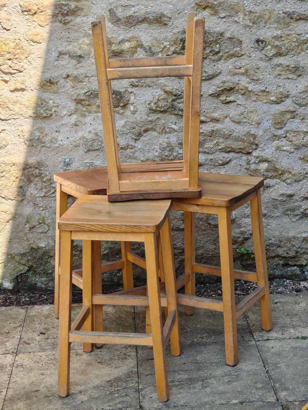 A group of rustic wooden lab stools