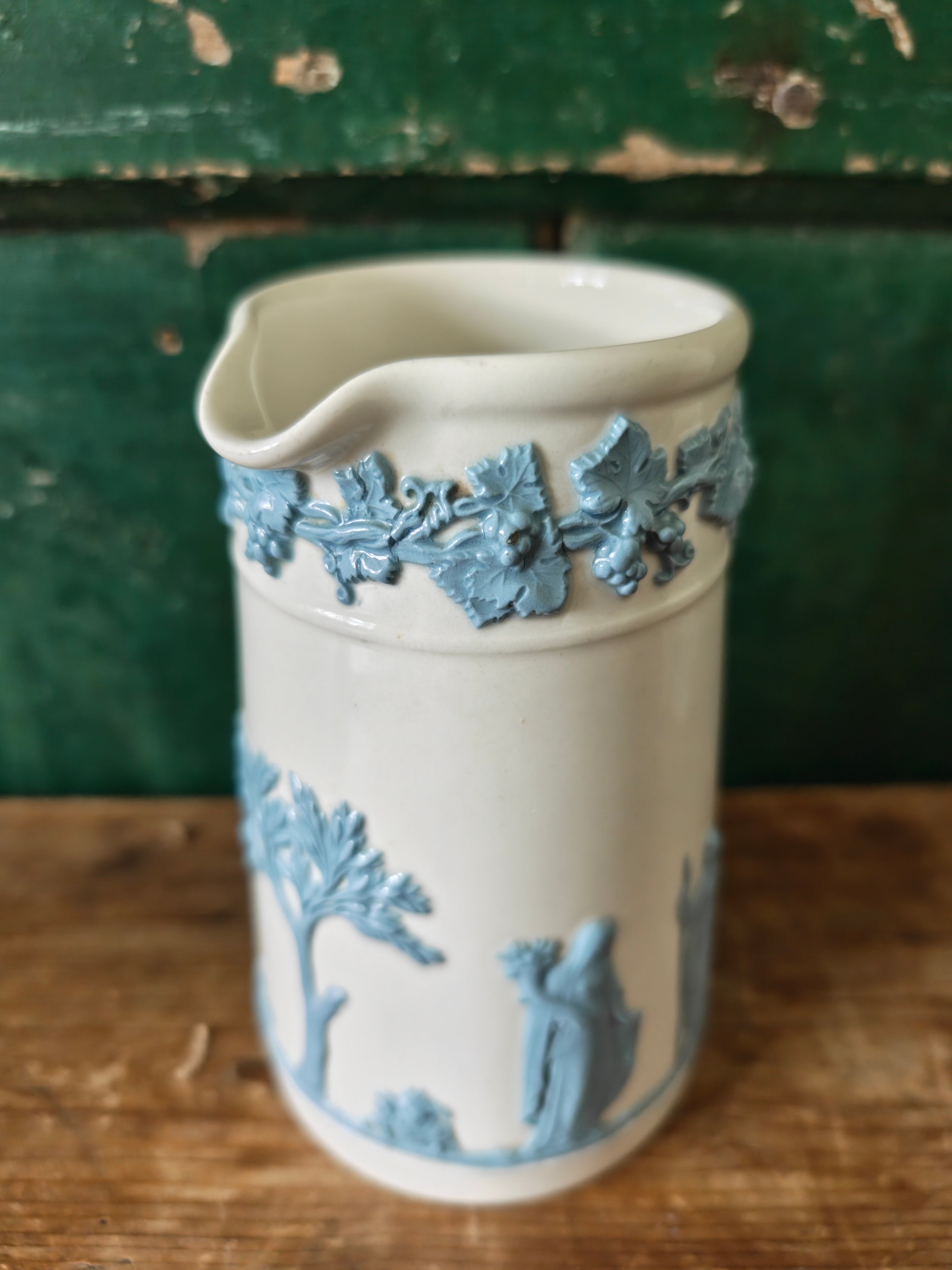 Ceramic jug with embossed blue and white design