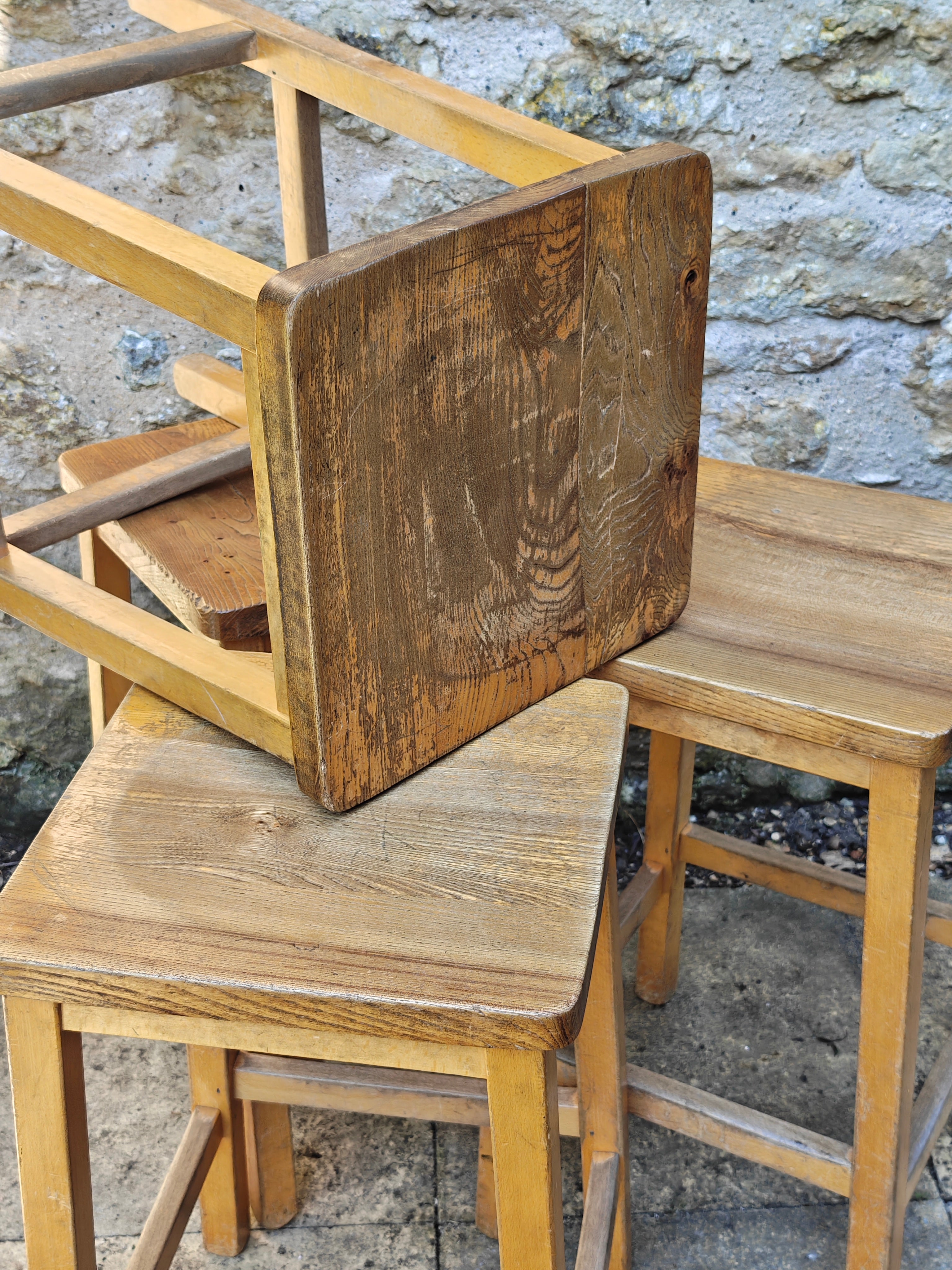 A group of rustic wooden lab stools