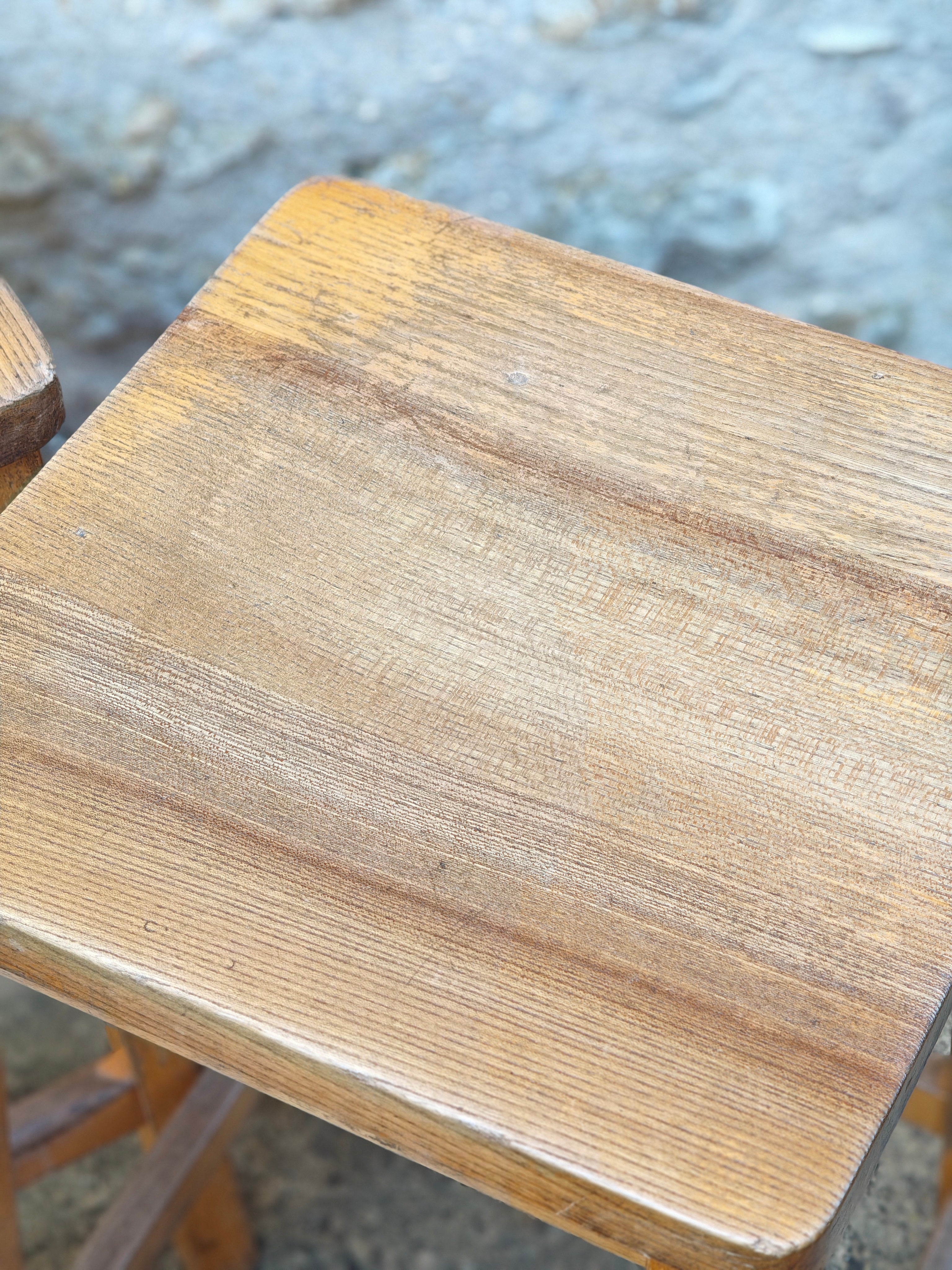 Close-up of the seat of a wooden lab stool